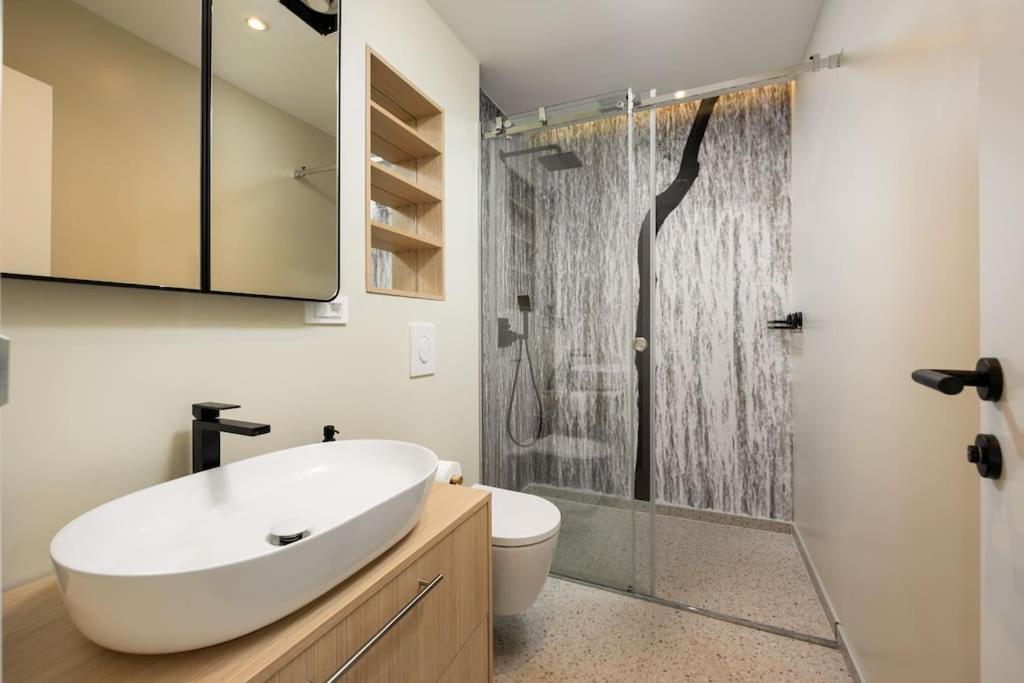 Bathroom with oval sink and walk-in shower