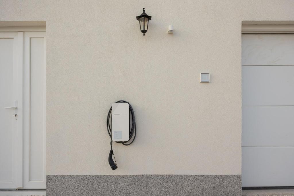 Electric vehicle charger on the house facade