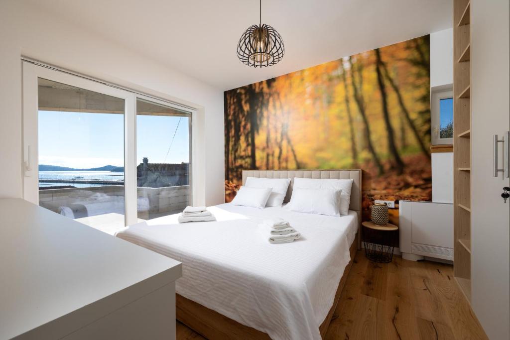 Bedroom with autumn forest mural and balcony view