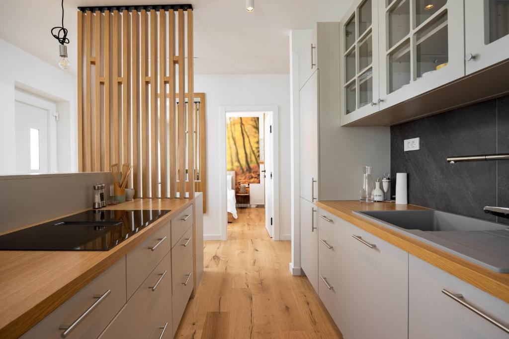 Galley kitchen and oak slat divider